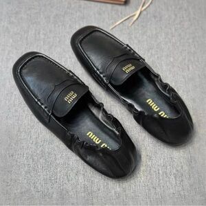 Miu Miu Black Leather Elastic-Back Penny Loafers with Gold Logo Accent
